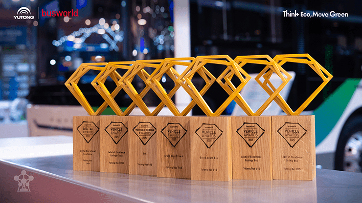 Row of Busworld Vehicle Awards trophies on a display counter.